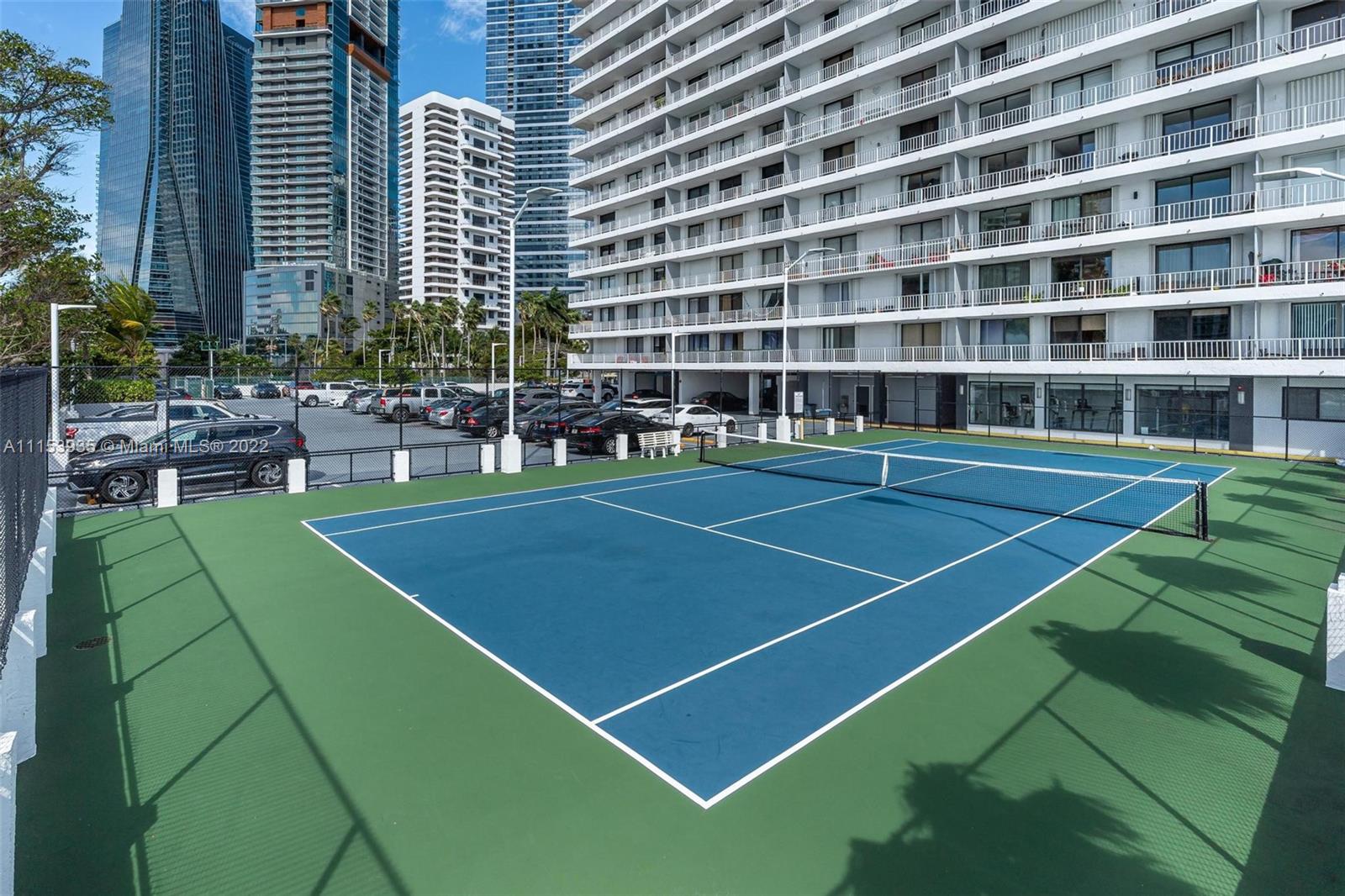 200 Southeast 15th Road, Unit 11H Miami, FL 33129 - Photo 5 of 20 a view of a tennis ground with large trees