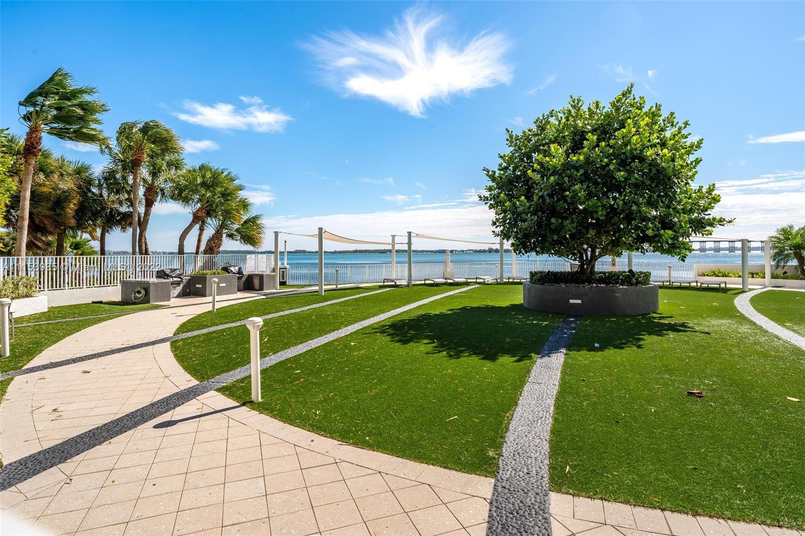 200 Southeast 15th Road, Unit 11H Miami, FL 33129 - Photo 8 of 20 a view of a swimming pool with a garden