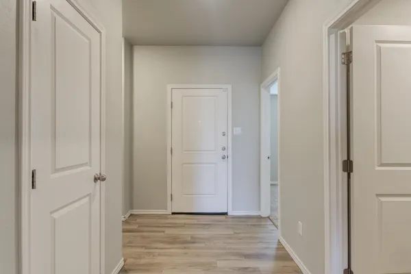 a view of a hallway with wooden floor