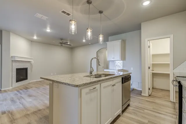 a view of a kitchen with a sink and dishwasher