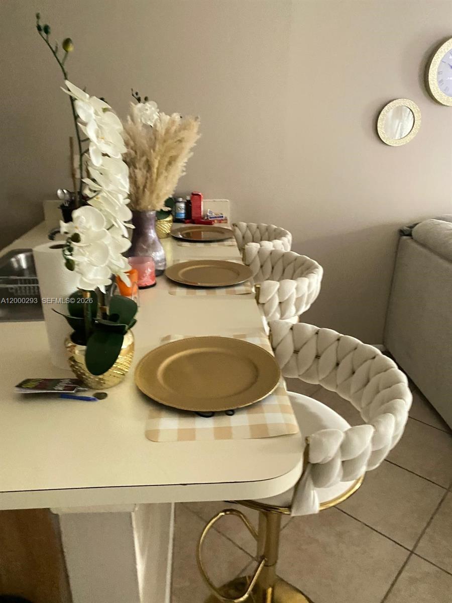 2701 Riverside Drive, Unit 316B Coral Springs, FL 33065 - Photo 2 of 7 a table with a vase and white flowers