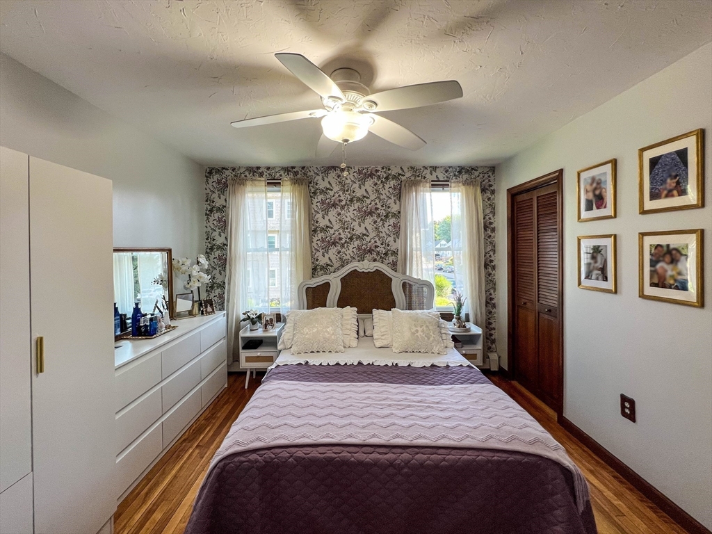 57 Vale Street Worcester, MA 01604 - Photo 14 of 42 a bedroom with a large bed and a large mirror