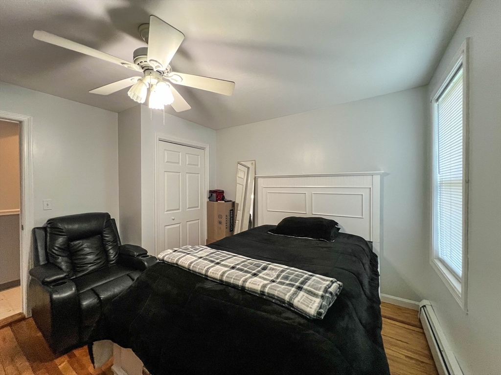 57 Vale Street Worcester, MA 01604 - Photo 16 of 42 a bedroom with a bed and a chandelier