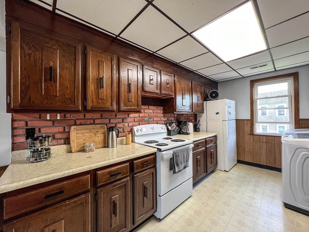 57 Vale Street Worcester, MA 01604 - Photo 18 of 42 a kitchen with a sink cabinets stainless steel appliances and a window