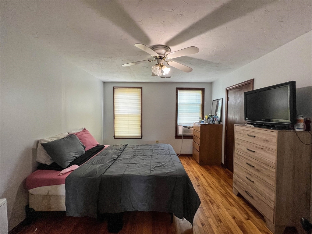 57 Vale Street Worcester, MA 01604 - Photo 25 of 42 a bedroom with a bed and a flat screen tv