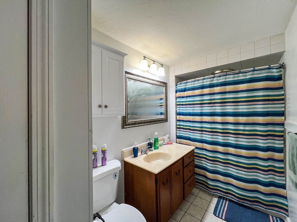 57 Vale Street Worcester, MA 01604 - Photo 30 of 42 a bathroom with a sink a mirror and a toilet