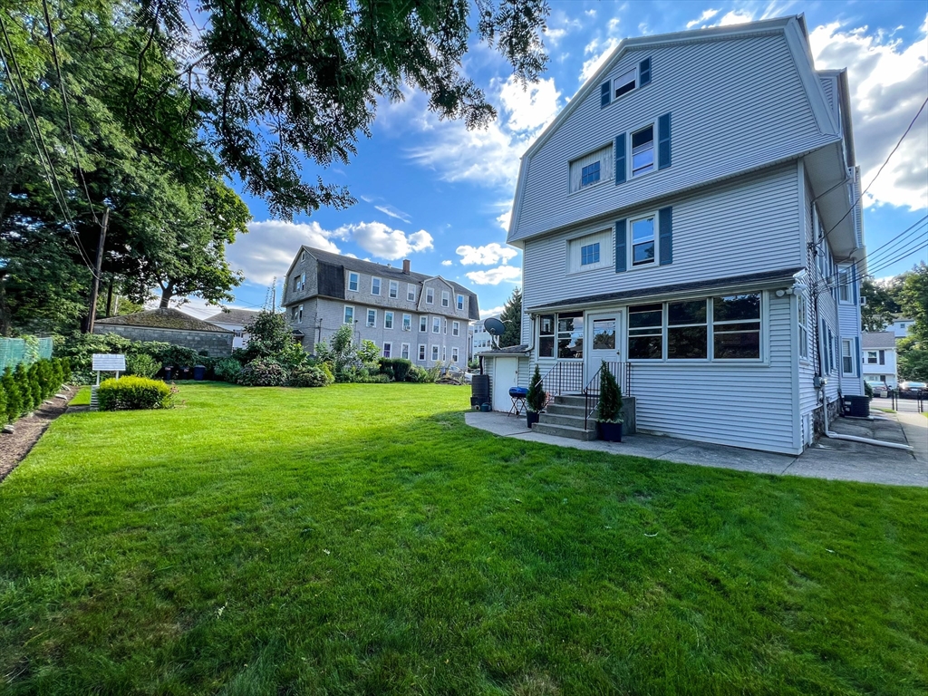 57 Vale Street Worcester, MA 01604 - Photo 3 of 42 a view of a house with a yard and sitting area