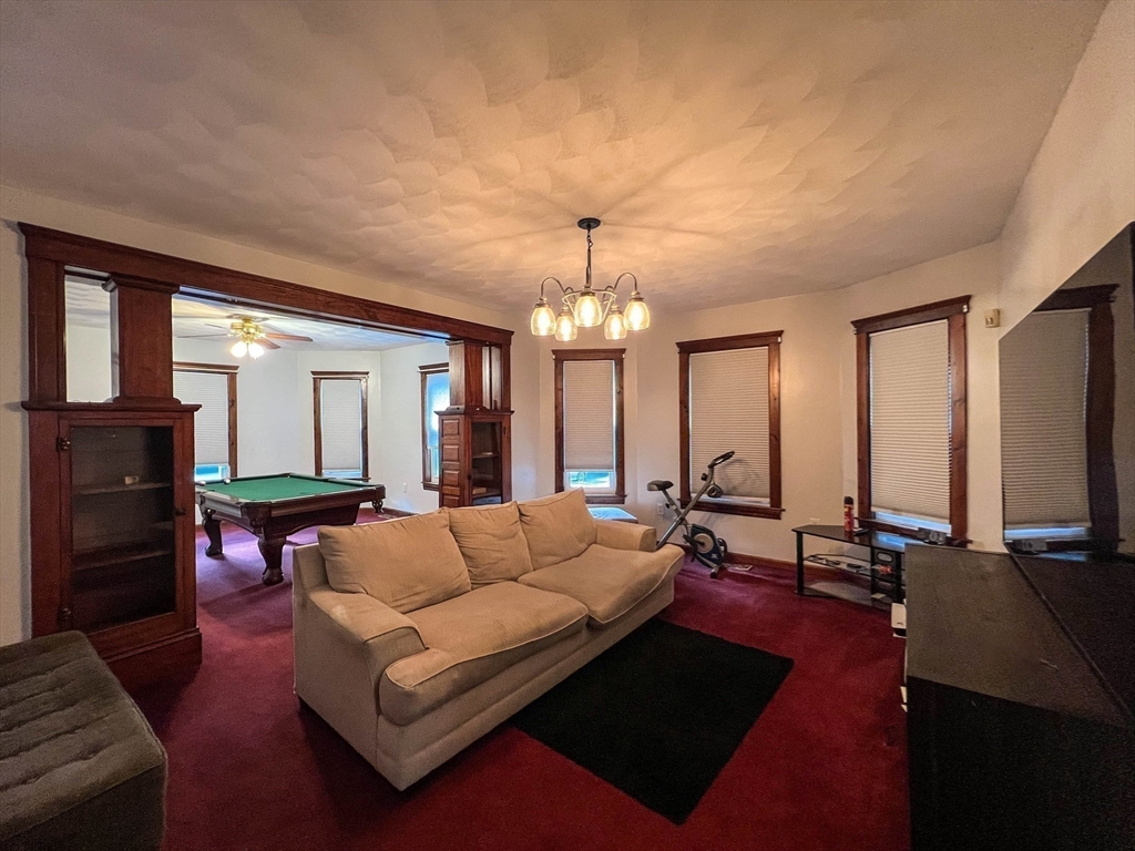 57 Vale Street Worcester, MA 01604 - Photo 31 of 42 a living room with furniture and a chandelier