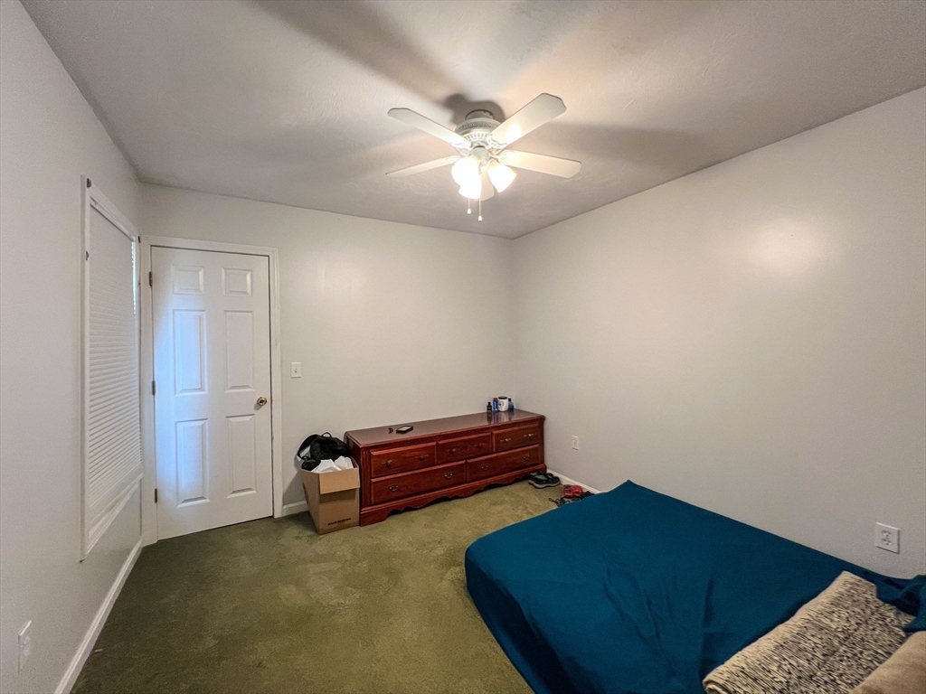 57 Vale Street Worcester, MA 01604 - Photo 34 of 42 a bedroom with a bed and a chandelier fan