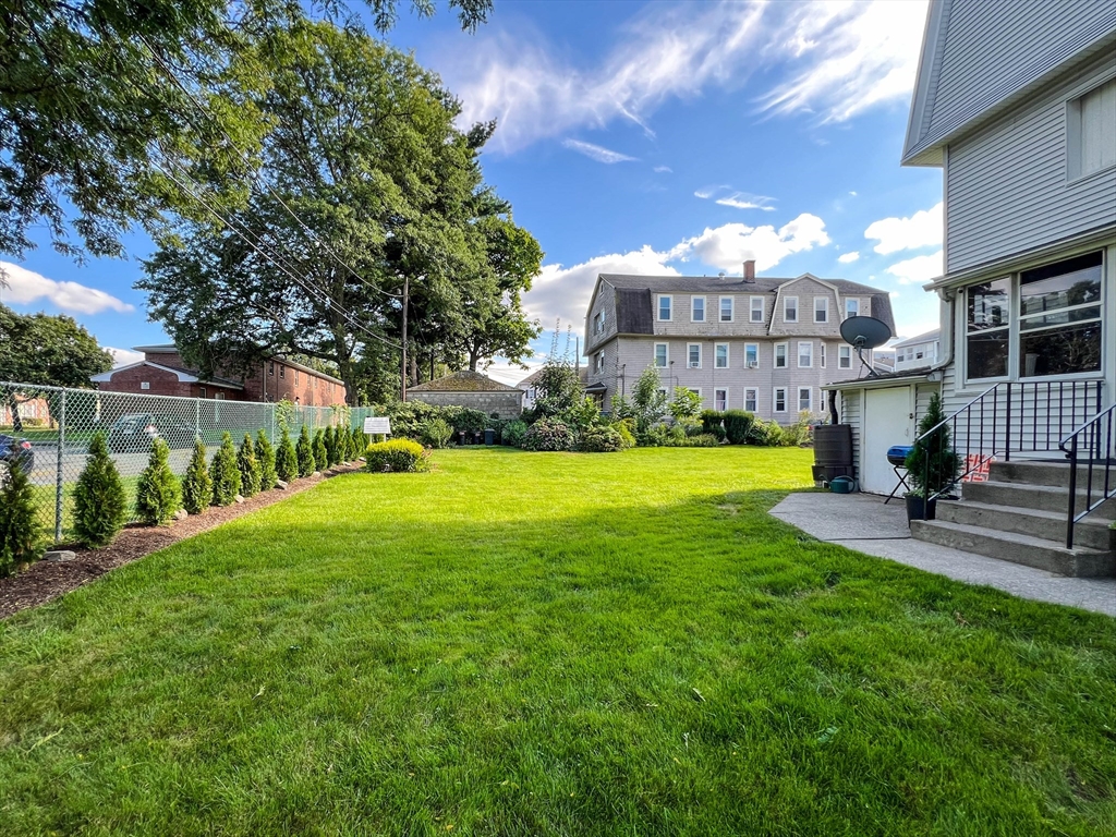 57 Vale Street Worcester, MA 01604 - Photo 4 of 42 a view of a house with a yard and a garden