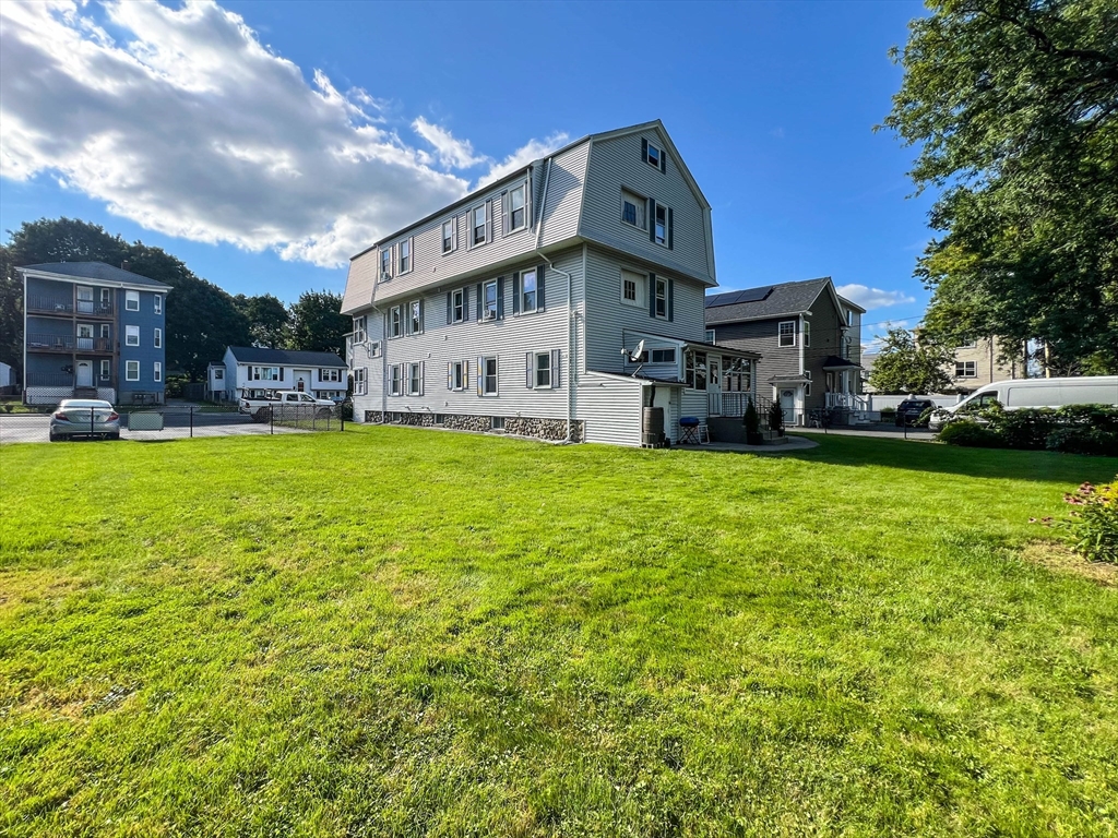 57 Vale Street Worcester, MA 01604 - Photo 5 of 42 a view of a house with a big yard and large trees