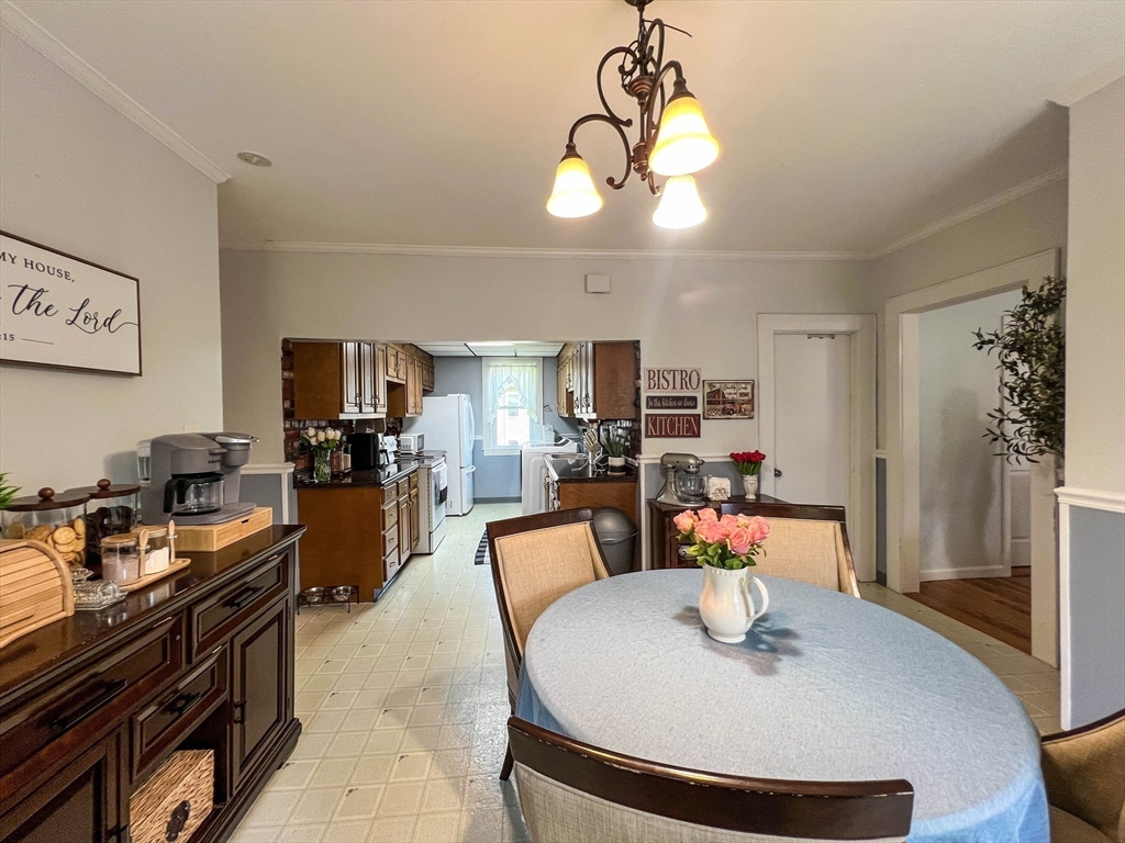 57 Vale Street Worcester, MA 01604 - Photo 9 of 42 a view of a dining room with furniture a chandelier and wooden floor