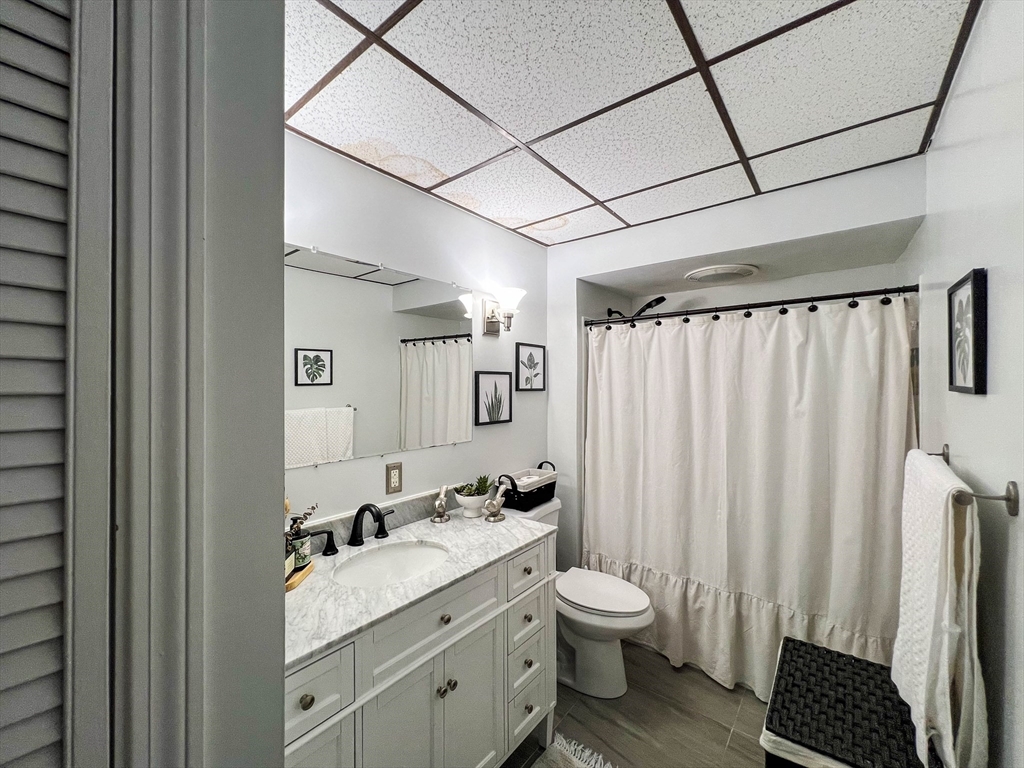 57 Vale Street Worcester, MA 01604 - Photo 10 of 42 a bathroom with a granite countertop sink toilet and shower