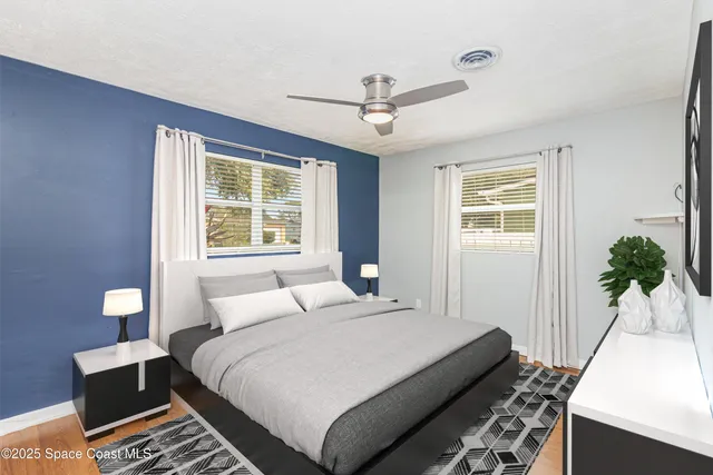 a bedroom with a large bed and a chandelier