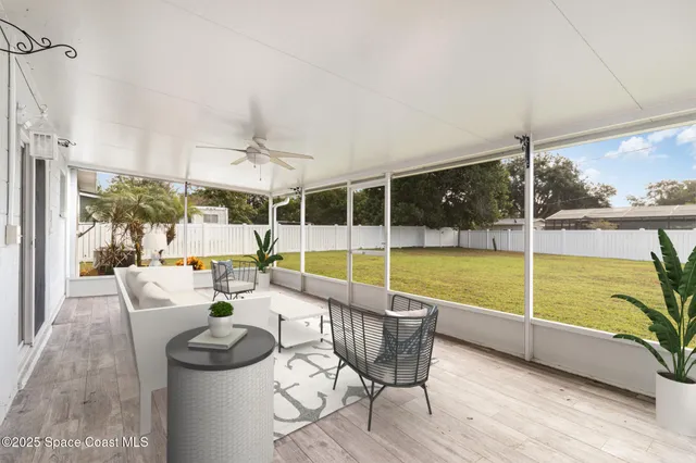 a dining room with furniture and a floor to ceiling window