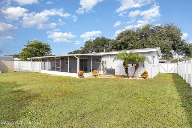 a view of backyard of house with seating space