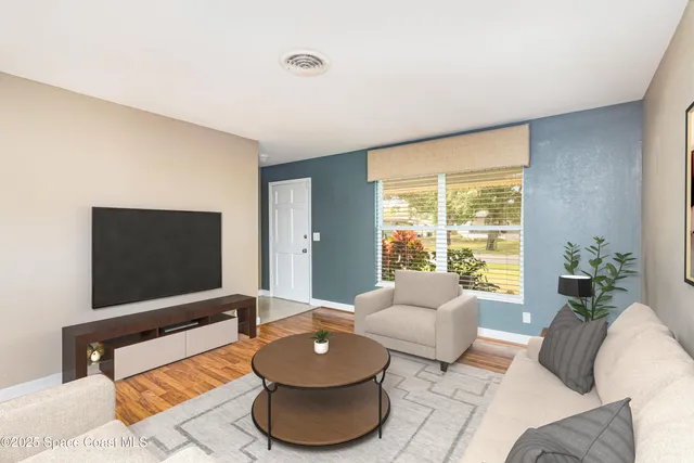 a living room with furniture and a flat screen tv