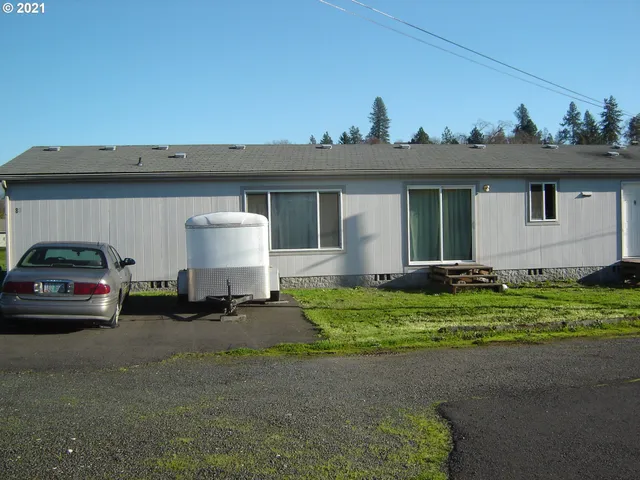 a couple of cars parked in front of a house