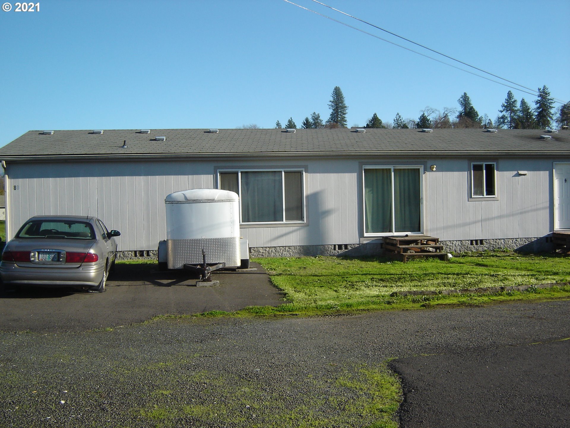 a couple of cars parked in front of a house