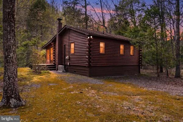 a view of house with backyard and trees