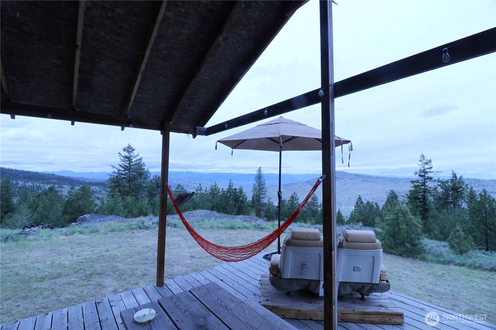 333 Patterson Creek Road Tonasket, WA 98855 - Photo 30 of 30 a view of a roof deck with wooden floor and fence