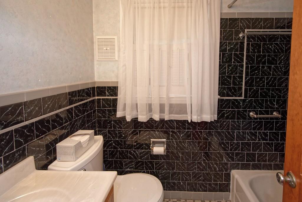 10 Eaton Road Framingham, MA 01701 - Photo 15 of 39 a bathroom with a toilet a sink and mirror