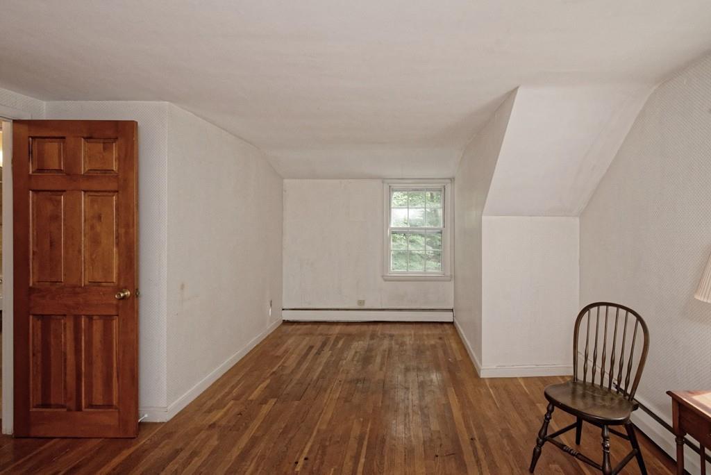 10 Eaton Road Framingham, MA 01701 - Photo 28 of 39 an empty room with wooden floor windows and entrance