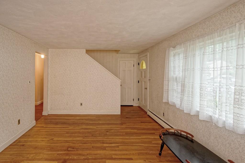 10 Eaton Road Framingham, MA 01701 - Photo 9 of 39 a view of an empty room with wooden floor and a window