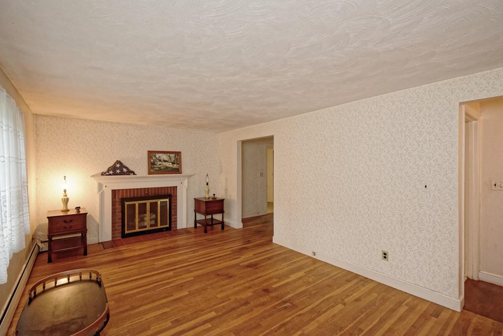 10 Eaton Road Framingham, MA 01701 - Photo 10 of 39 a living room with furniture and a fireplace