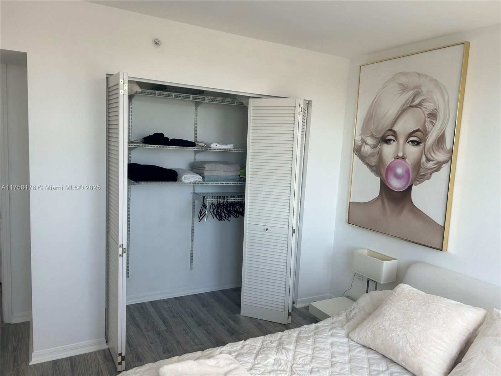 90 Alton Road, Unit 607 Miami Beach, FL 33139 - Photo 11 of 14 a bedroom with a bed and a view of bathroom