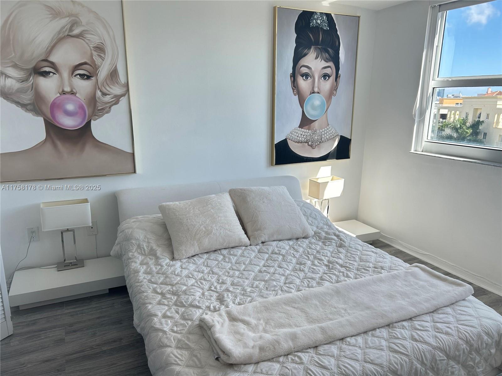 90 Alton Road, Unit 607 Miami Beach, FL 33139 - Photo 10 of 14 a bedroom with a bed and painting on the wall