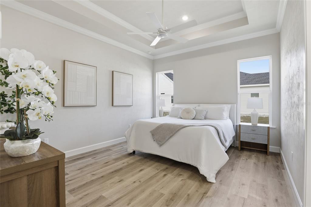 13425 Southwest 9th Road Newberry, FL 32669 - Photo 15 of 46 a bedroom with a bed and a potted plant