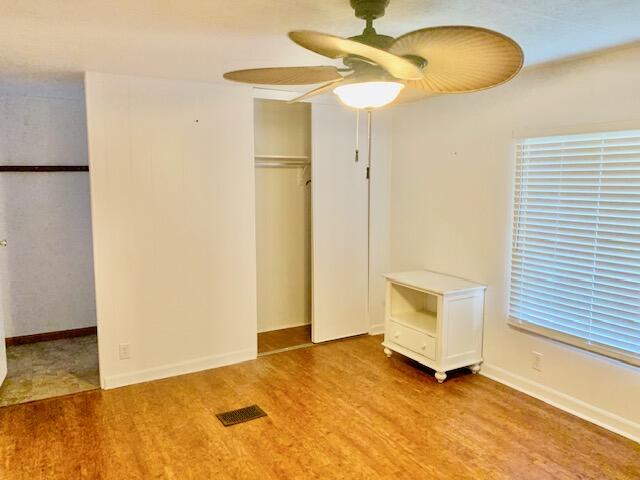 808 South Silver Circle Key Largo, FL 33037 - Photo 21 of 50 a view of an empty room with a window and wooden floor