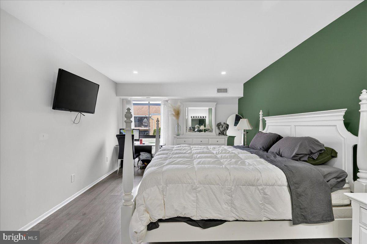 8930 Krewstown Road, Unit 310 Philadelphia, PA 19115 - Photo 16 of 32 a bedroom with a bed and a flat screen tv