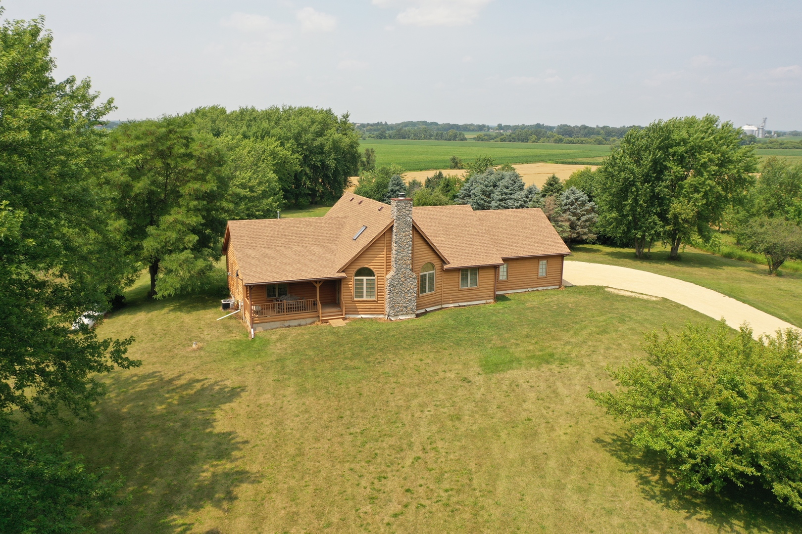23504 Flat Iron Road Harvard, IL 60033 - Photo 1 of 27 a view of a big house with a big yard and large tree