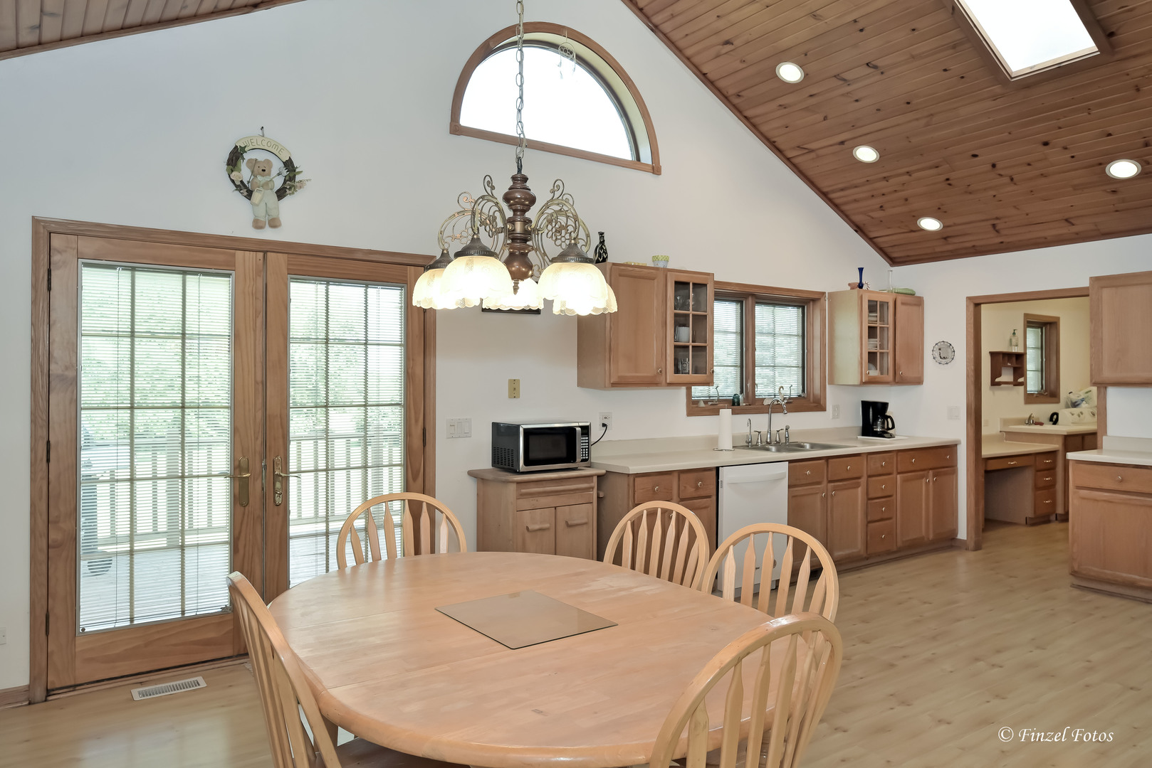 23504 Flat Iron Road Harvard, IL 60033 - Photo 11 of 27 a large kitchen with sink a dining table and chairs