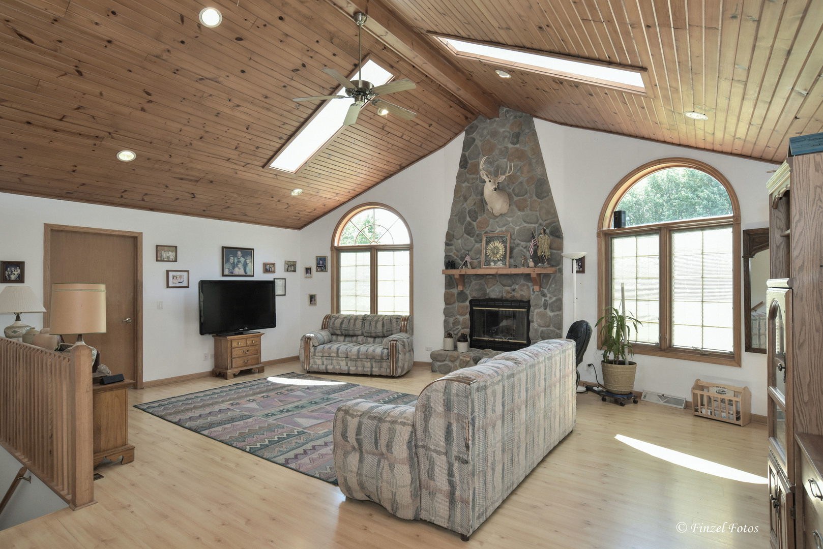 23504 Flat Iron Road Harvard, IL 60033 - Photo 8 of 27 a living room with furniture a fireplace and a flat screen tv