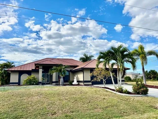 a view of a house with backyard and sitting area