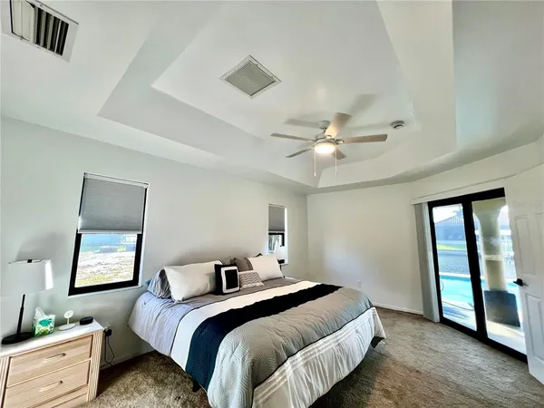 a bedroom with a bed and a chandelier