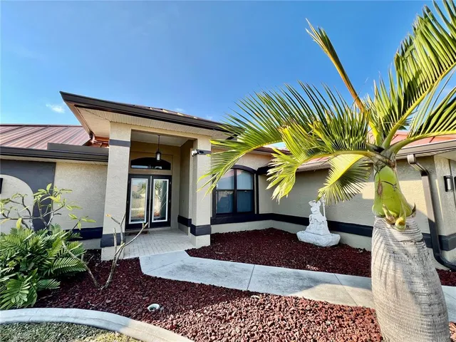 a view of a patio with a table and chairs under an umbrella