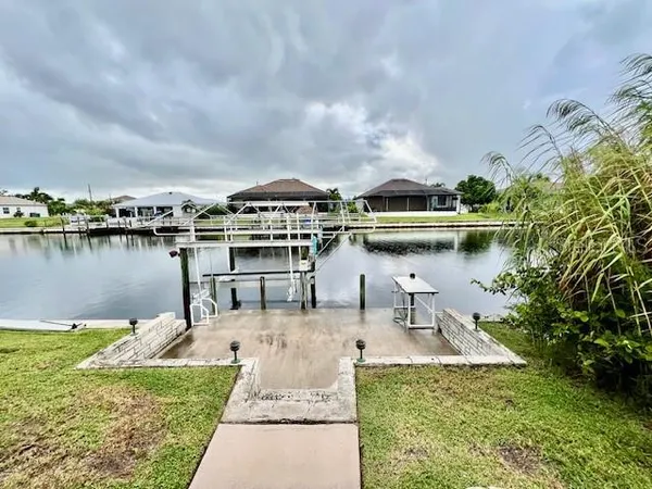 a kitchen with stainless steel appliances granite countertop a refrigerator a stove and a sink with cabinets