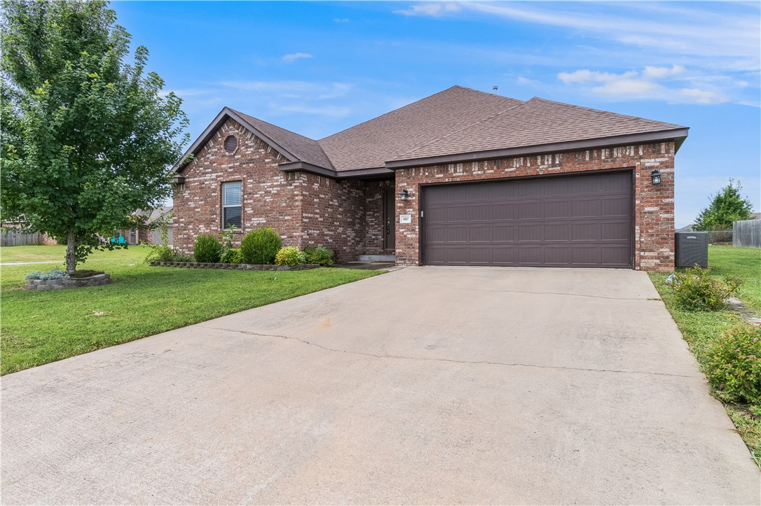457 Harper Drive Pea Ridge, AR 72751 - Photo 1 of 22 Brick exterior with a brown garage door, concrete driveway, and established landscaping