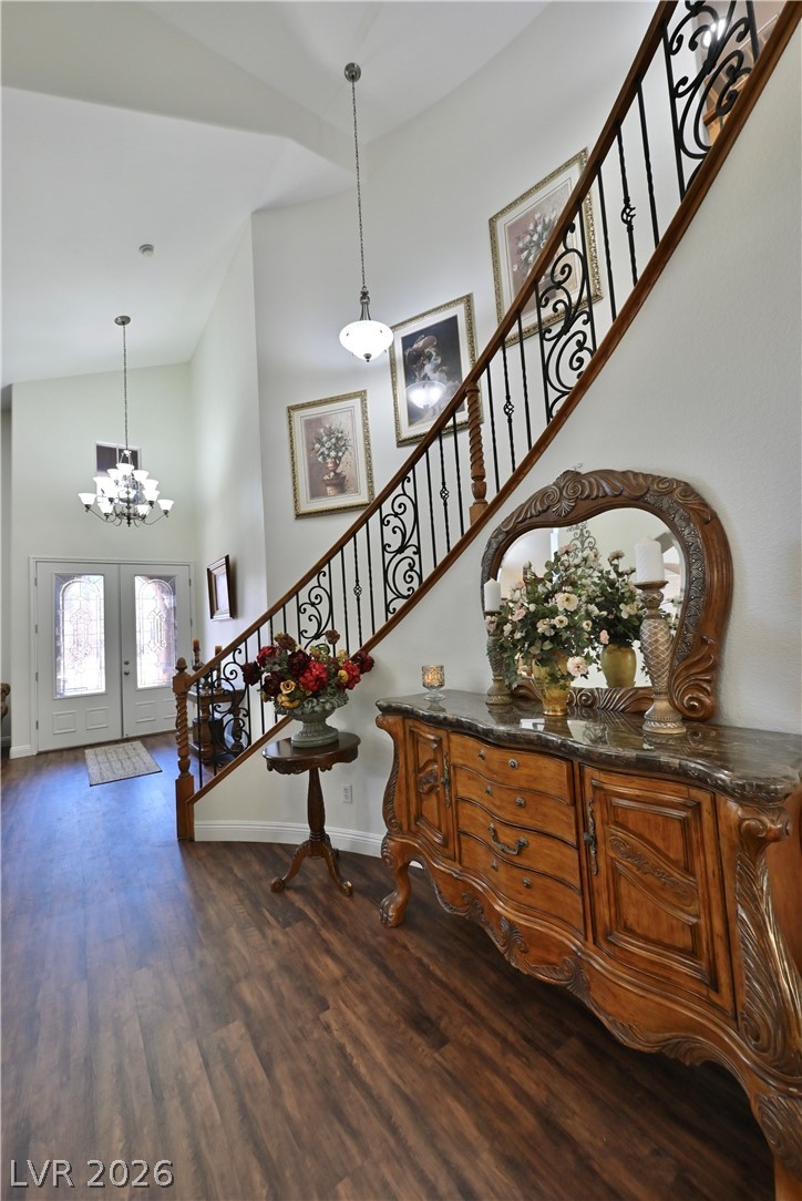 2729 Kildrummie Street Henderson, NV 89044 - Photo 16 of 42 A grand entrance with high ceilings, featuring a striking wooden staircase with intricate wrought iron balusters.
