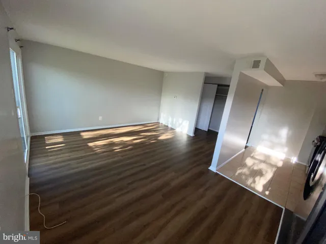 a view of an empty room and wooden floor