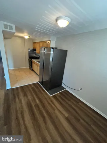 a view of kitchen with furniture and a refrigerator