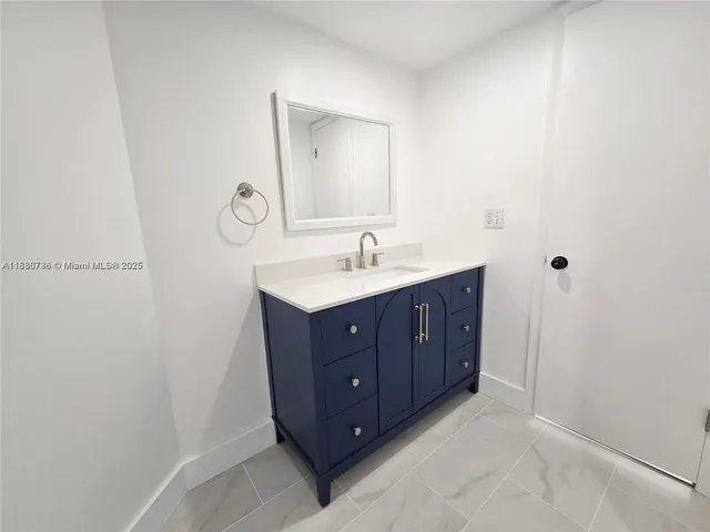 a bathroom with a vanity and a mirror