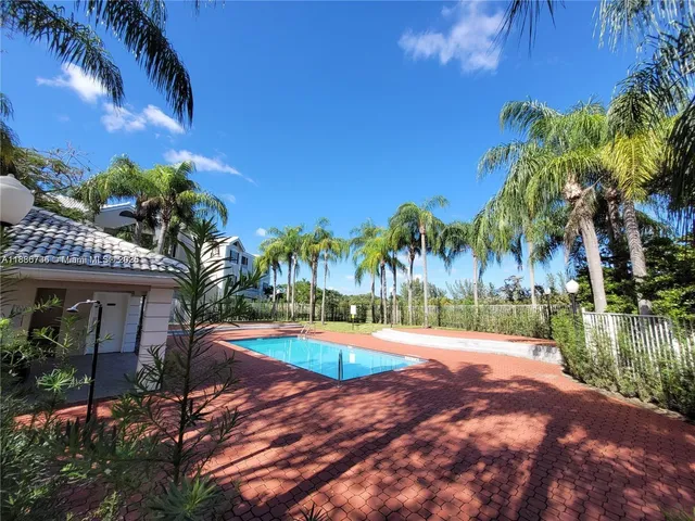 a view of a house with swimming pool and sitting area