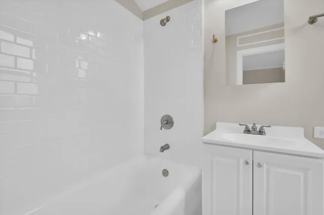 a bathroom with a sink mirror and toilet
