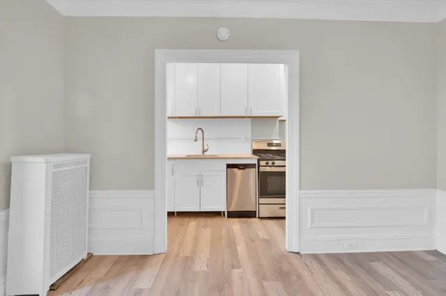a view of a kitchen with a stove top oven