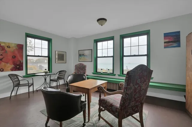 a view of a dining room with furniture and window